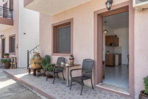 a patio with a table and chairs and a house at Frantzis studio 3 Nisyros in Páloi