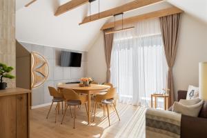a kitchen and dining room with a table and chairs at Przy Szlaku in Zawoja