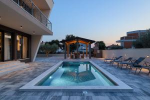 a swimming pool in the middle of a house at Cherry House in Medulin