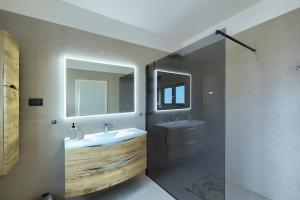 a bathroom with a sink and a mirror at Cherry House in Medulin +18 photos