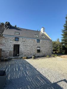 a brick building with a driveway in front of it at Nature break in a farmhouse near Vannes in Grand-Champ