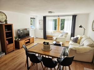 a living room with a table and a couch at Ferienwohnung Lieblingszeit in Unterwössen