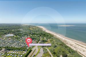 an overhead view of a beach with a red stop sign at Welcome in - Strandvilla's dichtbij het strand - Vakantiepark Zonnedorp Renesse in Renesse