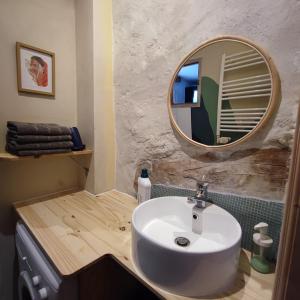 a bathroom with a white sink and a mirror at Gîte L'Atelier in Saint Martin sur Lavezon