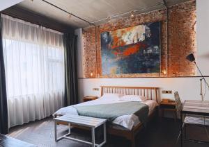 a bedroom with a bed and a painting on the wall at Suzhou Unique Space Design Art Hotel in Suzhou