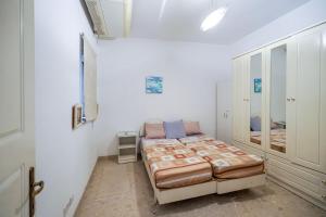 a bedroom with a bed in a white room at Waterfront Panorama Massive Three Bedrooms Flat 8S in Sliema