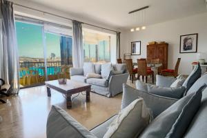 a living room with couches and a table with a view at Waterfront Panorama Massive Three Bedrooms Flat 8S in Sliema