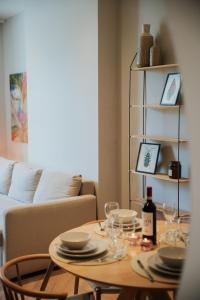 a table with plates and wine glasses and a couch at Naest - Authentic Escapes Old Town Villa Nijmegen in Nijmegen +85 photos