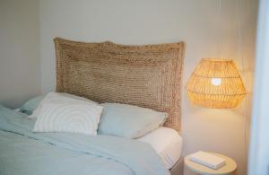 a bed with two pillows and a lamp next to it at Naest - Authentic Escapes Old Town Villa Nijmegen in Nijmegen