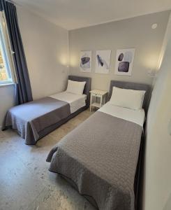 two beds in a room with two beds sidx sidx sidx sidx at House Rosa in Mali Lošinj