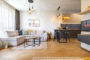 a living room with a couch and a kitchen at Azur Alegria Luxury Studio with Pool Access in Saints Constantine and Helena