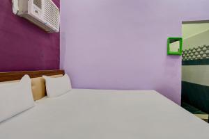 a white bed with two pillows in a room at Hotel O Chaudhary Hotel in Tatārpur