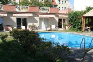 a swimming pool in front of a house at Hotel-Park-Residenz in Aschersleben