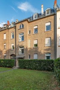 a large brick building with bushes in front of it at Family Apartment in Wiesbaden