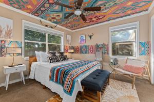1 dormitorio con 1 cama con techo pintado en Memories on Mulberry- Hot Tub Game Room Fire Pit, en Fredericksburg