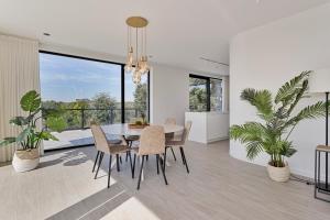 a dining room with a table and some plants at Faro Greenpark, Cadzand-Bad Penthouse in Cadzand