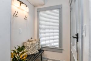 a hallway with a window and a bench with a plant at 15 Hypolita in St. Augustine
