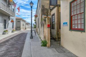 an empty street with a street light next to a building at 15 Hypolita in St. Augustine