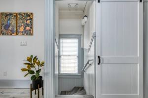 a hallway with a white door and a plant at 15 Hypolita in St. Augustine +41 photos