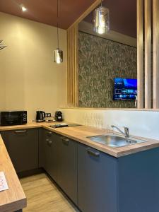 a kitchen with a sink and a counter at Secret Room in Le Puy en Velay +4 photos