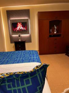 a bedroom with a bed with a fire in the window at habitación pequeña in Bogotá +2 photos