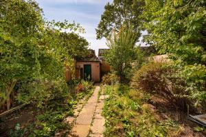 a garden path with a house in the background at Contractors - Businesses - Families - Long term Stays - Free parking in Thornton Heath