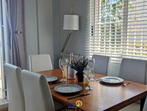a dining room table with chairs and a wooden table with glasses at Los Dolses Family Villa with Private Pool LD07 in Los Dolses
