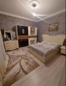 a bedroom with a bed and a painting on the wall at Kiraye in Novxanı