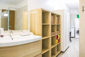 a bathroom with a sink and a mirror at La Vega de Mary in Arrecife +26 photos