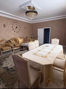 a large dining room with a table and chairs at Kiraye in Novxanı