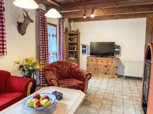 a living room with a couch and a television at Holiday Home Mühlberg by Interhome in Holzhammer