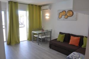 a living room with a couch and a table at Nice Apartment 1210 In Central Area in San Bartolomé de Tirajana