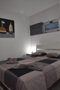 a bedroom with two beds and a window at Nice Apartment 1210 In Central Area in San Bartolomé de Tirajana