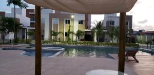 una piscina con tavolo e ombrellone di Mer Bleue du Français a Marechal Deodoro