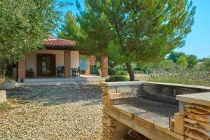 a house with a fire pit in a yard at Rose-Marin in Medulin (Haus für 2 Personen) in Medulin +7 photos