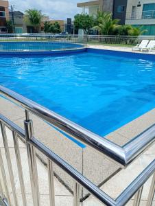a large swimming pool with blue water at Casa Cop30 Belém in Belém