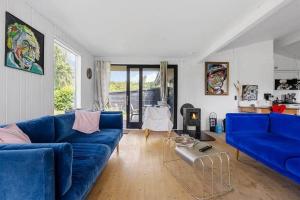 a living room with blue couches and a table at SB116-Sydals-Birkemose-29 in Skovbyballe