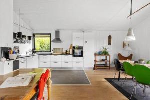 a kitchen with white cabinets and a table in a room at SB116-Sydals-Birkemose-29 in Skovbyballe