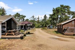 un grupo de edificios con un camino de tierra al lado de una casa en 3715-Nexo-Klynevej-42, en Snogebæk