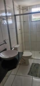 a bathroom with a sink and a toilet at Casa da Jussara in Itaperuna