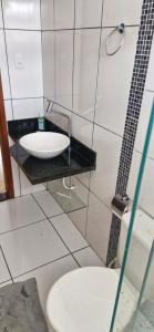 a bathroom with a sink and a toilet at Casa da Jussara in Itaperuna