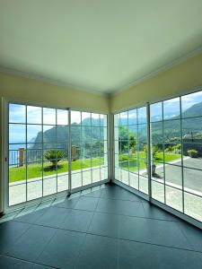 a room with large windows with a view of the ocean at Vista Ventura in Ponta Delgada