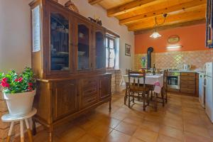 a kitchen with a large wooden cabinet and a table at Galant in Prkačini (Haus für 4-5 Personen) in Žminj