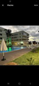 a building with a swimming pool in front of a building at appartement de lux vue piscine 5 min plage bouznika in Bouznika