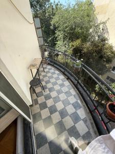 a view of a balcony with a checkerboard floor at Cisimigu Garden Studio in Bucharest