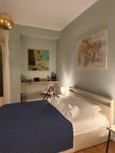 a bedroom with a large bed with a blue blanket at Cisimigu Garden Studio in Bucharest