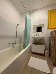 a bathroom with a white tub and a sink at Cisimigu Garden Studio in Bucharest