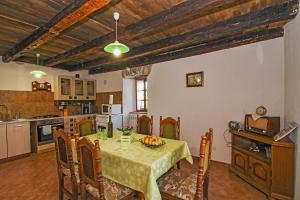 a kitchen and dining room with a table and chairs at Erika in Šumber (Haus für 4-6 Personen) in Nedeščina +20 photos