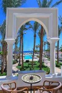 a view of a resort with palm trees and a fountain at JAZ Fanara Resort in Sharm El Sheikh +39 photos