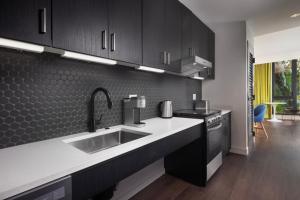 a kitchen with a sink and a stove at The Artful Way Hotel in Asheville